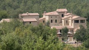 a large building in the middle of a forest at Relais Azienda Casalino in Toppole