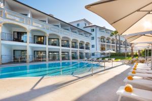 a hotel with a swimming pool in front of a building at Iberostar Selection Andalucia Playa in Chiclana de la Frontera