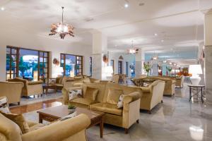 a large lobby with couches and tables and windows at Iberostar Selection Andalucia Playa in Chiclana de la Frontera