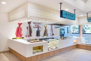 a bakery counter with food on display in a store at Iberostar Selection Andalucia Playa in Chiclana de la Frontera
