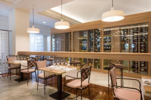 a restaurant with tables and chairs and wine racks at Iberostar Selection Andalucia Playa in Chiclana de la Frontera