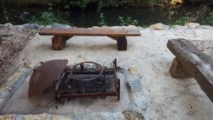 a wooden bench and a wooden table and a bench at Holiday Home Kite House in Ulcinj