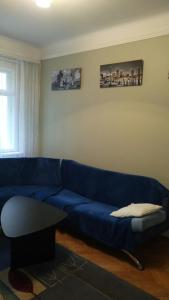 a living room with a blue couch and a table at Apartment with courtyard in Lviv