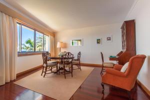 a living room with a dining room table and chairs at 6001 by RMC in Funchal