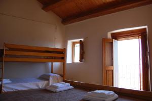 A bed or beds in a room at Case Rurali Pentedattilo