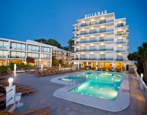 hotel z basenem przed budynkiem w obiekcie Bellamar Hotel Beach & Spa w mieście San Antonio
