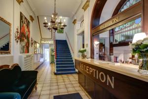 a hotel lobby with a reception counter and stairs at Trip Inn Hotel Blankenburg in Karlsruhe