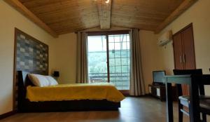 a bedroom with a bed and a large window at 솔향기펜션 in Hongcheon +85 photos