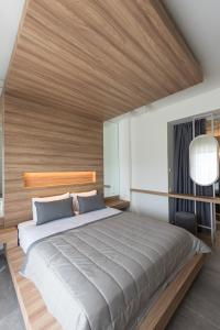 a bedroom with a large bed with a wooden ceiling at Fani Luxury Boutique in Stavros