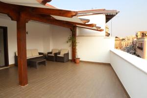 a balcony with a table and chairs on a building at Affittacamere Massimo D'Azeglio in Barletta