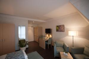 a living room with a couch and a table in a room at Weingut & Gästehaus Schmitz-Bergweiler in Bernkastel-Kues