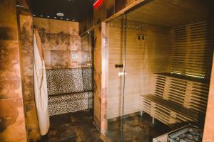 a bathroom with a shower and a glass door at Hanza Hotel in Riga