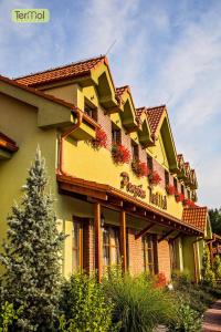 a building with flowers on the side of it at Penzion Termal in Bojnice