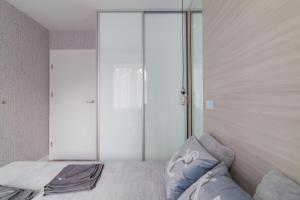 a bedroom with a bed with a large glass door at Dwie Sosny - Apartament 48 in Ustronie Morskie +32 photos