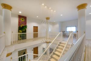 a staircase in a building with a painting on the wall at Iberostar Selection Andalucia Playa in Chiclana de la Frontera