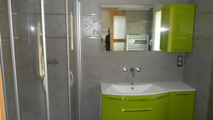 a bathroom with a green sink and a shower at Villa Dikaria in Montacher +28 photos
