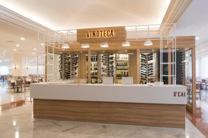 a wine store with a counter in a building at Iberostar Selection Andalucia Playa in Chiclana de la Frontera