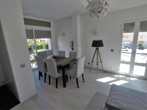 a dining room with a table and chairs and a chandelier at Vilamoura in Vilamoura