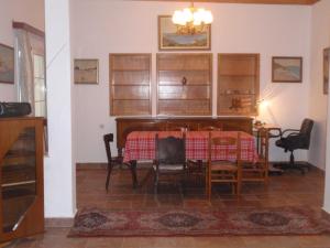 a dining room with a table and chairs in a room at Traditional city house in Kalymnos