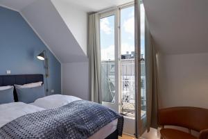 a bedroom with a bed and a large window at Copenhagen Strand in Copenhagen
