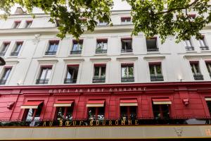 a large white building with a red facade at Hotel Restaurant Au Boeuf Couronné in Paris