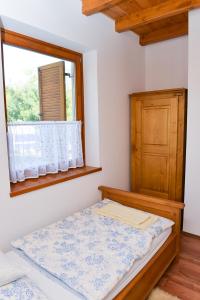 a small bedroom with a bed and a window at Fekete Lovastanya in Kiskunfélegyháza