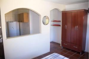 a bathroom with a mirror and a cabinet in a room at Ohana Beach in Saquarema