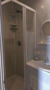 a bathroom with a shower and a sink at Havelock Guesthouse in Saint Helier Jersey