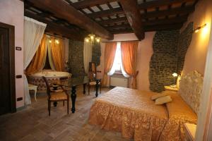 a bedroom with a bed and a bathroom with a tub at Relais Castrum Boccea in Boccea +71 photos