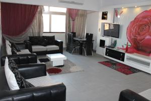a living room with a couch and a tv at Apartment at Milsa Nasr City, Building No. 30 in Cairo