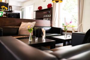 
a living room filled with furniture and flowers at FT Hotel & Restaurant in Freiburg im Breisgau
