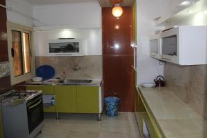 a small kitchen with a sink and a stove at Apartment at Milsa Nasr City, Building No. 36 in Cairo