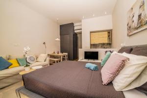 a living room with a bed and a couch at Doma Zagreb Aparthotel in Zagreb