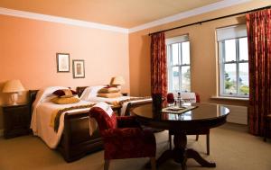 a hotel room with two beds and a table at Ardmore Country House in Westport