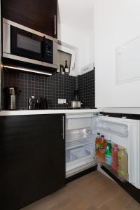 a kitchen with an open refrigerator with food in it at Main Apartment Frankfurt Offenbach in Offenbach