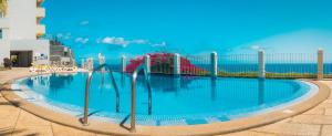 a large swimming pool in front of the ocean at 6001 by RMC in Funchal