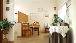 a room with a table with a vase of flowers on it at Hostal Arli in San Francisco