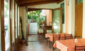 a restaurant with tables and chairs on a patio at Stavrodromi Hotel in Igoumenitsa