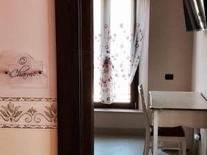 a room with a window with a table and a table and chair at Eleven Bed & Breakfast in Reggio Calabria