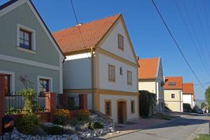 a large white house with a red roof at Apartmán Tilia in Pavlov