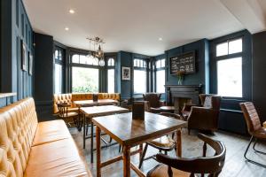 a restaurant with tables and chairs and a chalkboard at The Porterhouse grill & rooms in Oxford