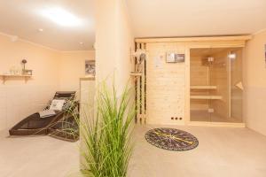 a bathroom with a walk in shower and a glass door at Villa Manatee mit Sauna & Fitness in Ostseebad Sellin +32 photos