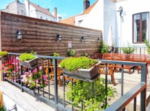 a patio with some plants on a fence at Hostel Lybeer Private Rooms just for two! in Bruges +41 photos