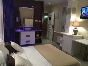 Postel nebo postele na pokoji v ubytování Hotel Le Cilaos