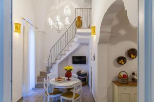 une salle à manger avec une table et un escalier dans l'établissement Dimore del Faso, à Fasano