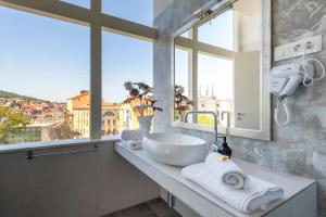 a bathroom with a sink and a large window at Prima Luce Downtown - MAG Quaint & Elegant Boutique Hotels in Split