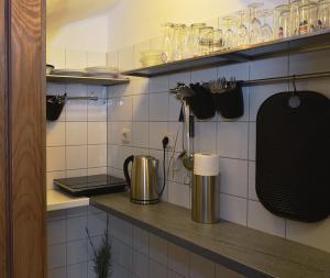 a kitchen with a counter with utensils on the wall at Várfal Vendégház in Fertőrákos