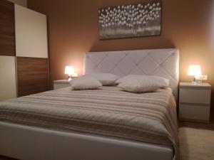 a bedroom with a large bed with two pillows at Ivana Šibenik in Šibenik