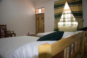 a bedroom with two beds and a window at Nilaveli Star View Hotel in Nilaveli +31 photos