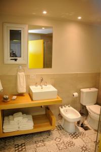 a bathroom with a sink and a toilet at Azar Departamentos Tandil in Tandil